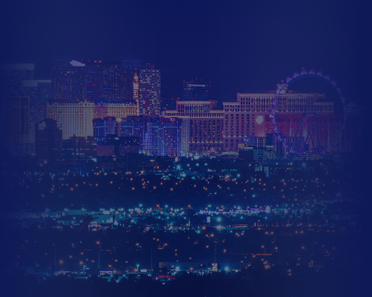 City skyline at night with faint lights and buildings.